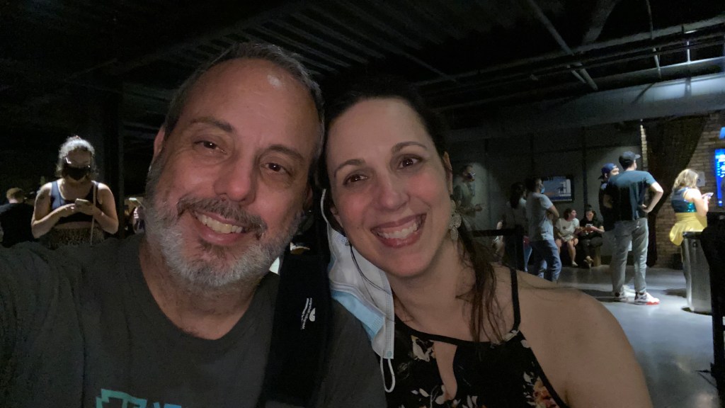 Rebecca and her friend smiling in their private seating area