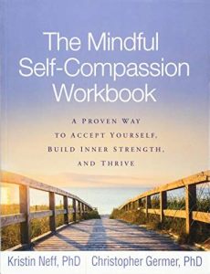 Book cover reading "The Mindful Self-Compassion Workbook" over an image of a wooden walkway leading to a beach